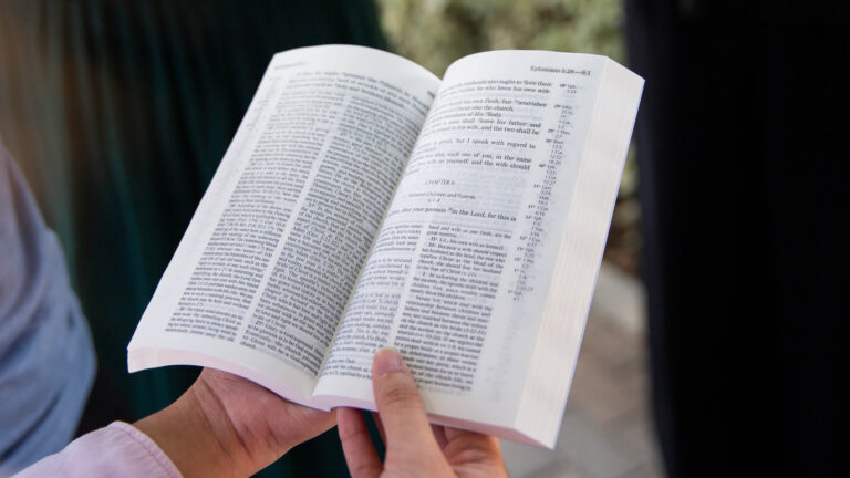 open Bible held by person